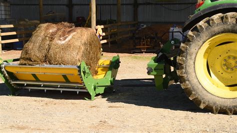 skid steer to lift round bails|bale unroller for cattle.